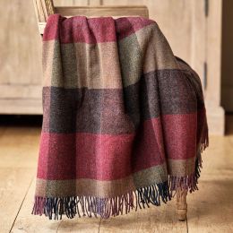checked wool throw in shades of red, purple and brown draped over a wooden chair