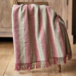 rose pink and beige striped wool throw with tassel fringe edge, draped over a wooden chair