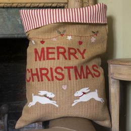 Jute Christmas sack lined with red and white striped fabric and embroidered with the words Merry Christmas and two white hares. 