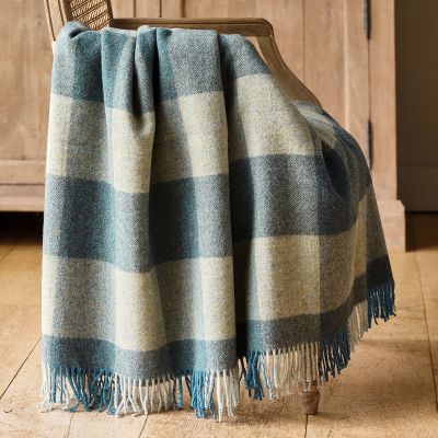 checked wool throw in shades of deep blue with a fringe edge