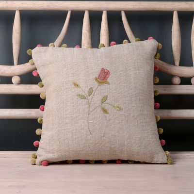 Feather filled rustic linen cushion with embroidered rosebud detail and pompom edge. 