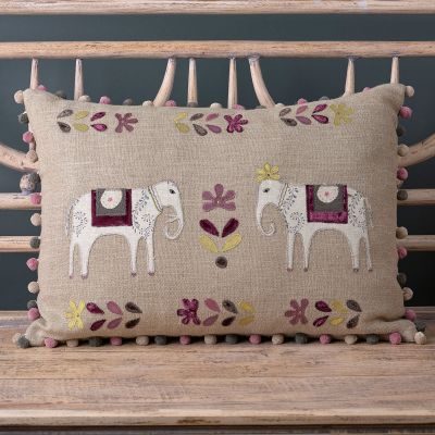 linen cushion with two applique elephants and leaf detail in shades of charcoal and purple and a pompom edge