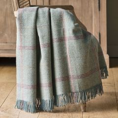 pale blue tartan wool throw with stripes of orange and pink and fringe edge