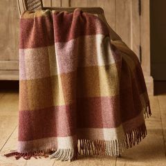 wool check throw in shades of red and gold draped over a chair